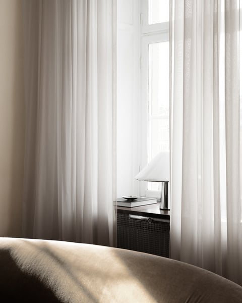 Modern sheer curtains layered with blackout drapes