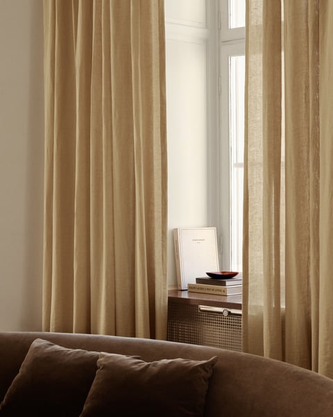 Sheer curtains allowing natural light into the bedroom