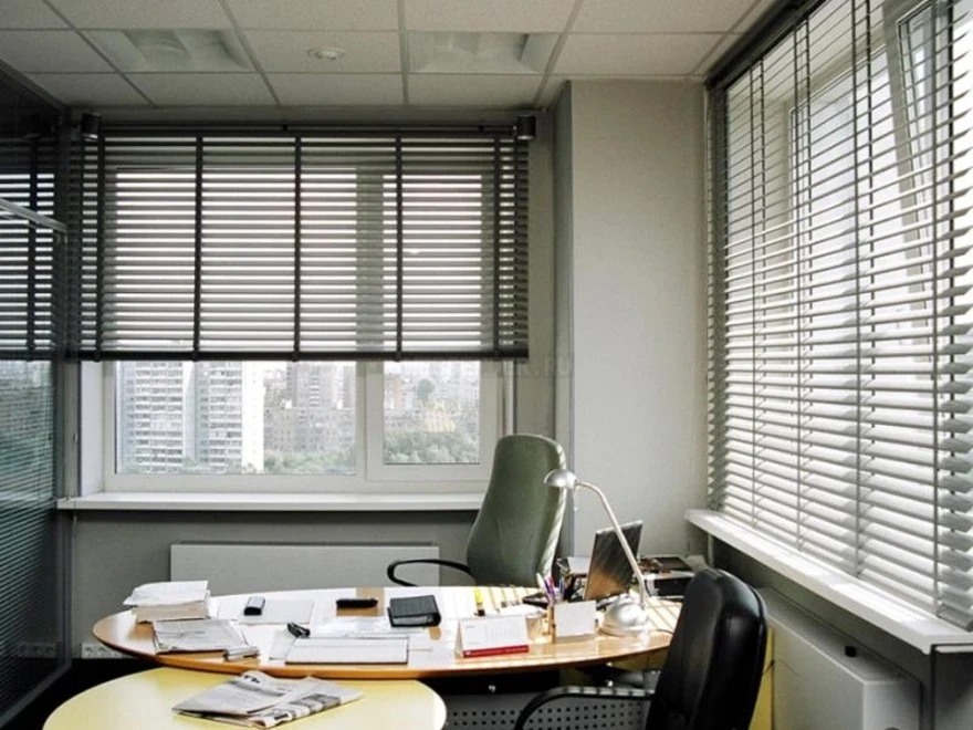 Office blinds partially open allowing daylight