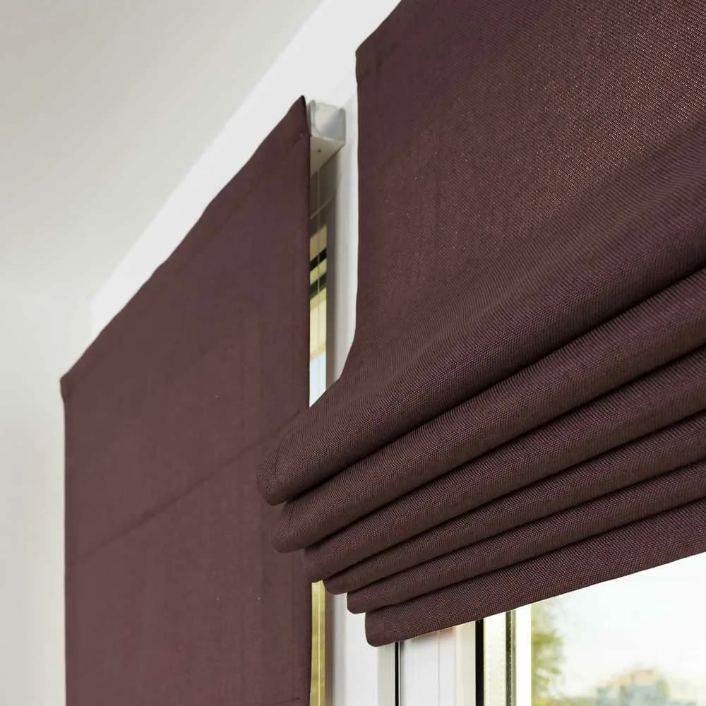 Roman blinds folded at the top of a window.