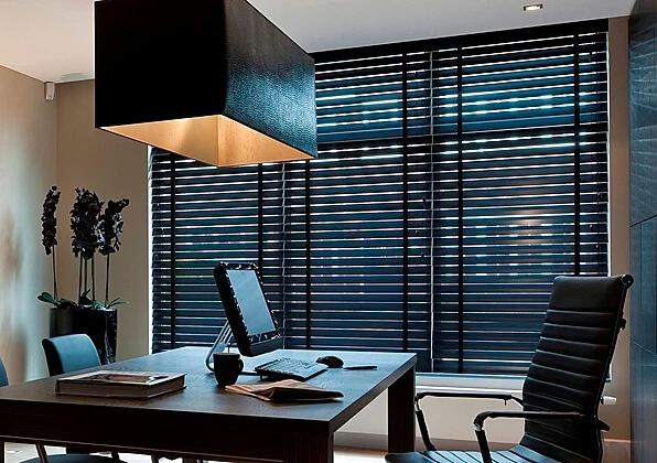 Office blinds adjusting sunlight inside workspace